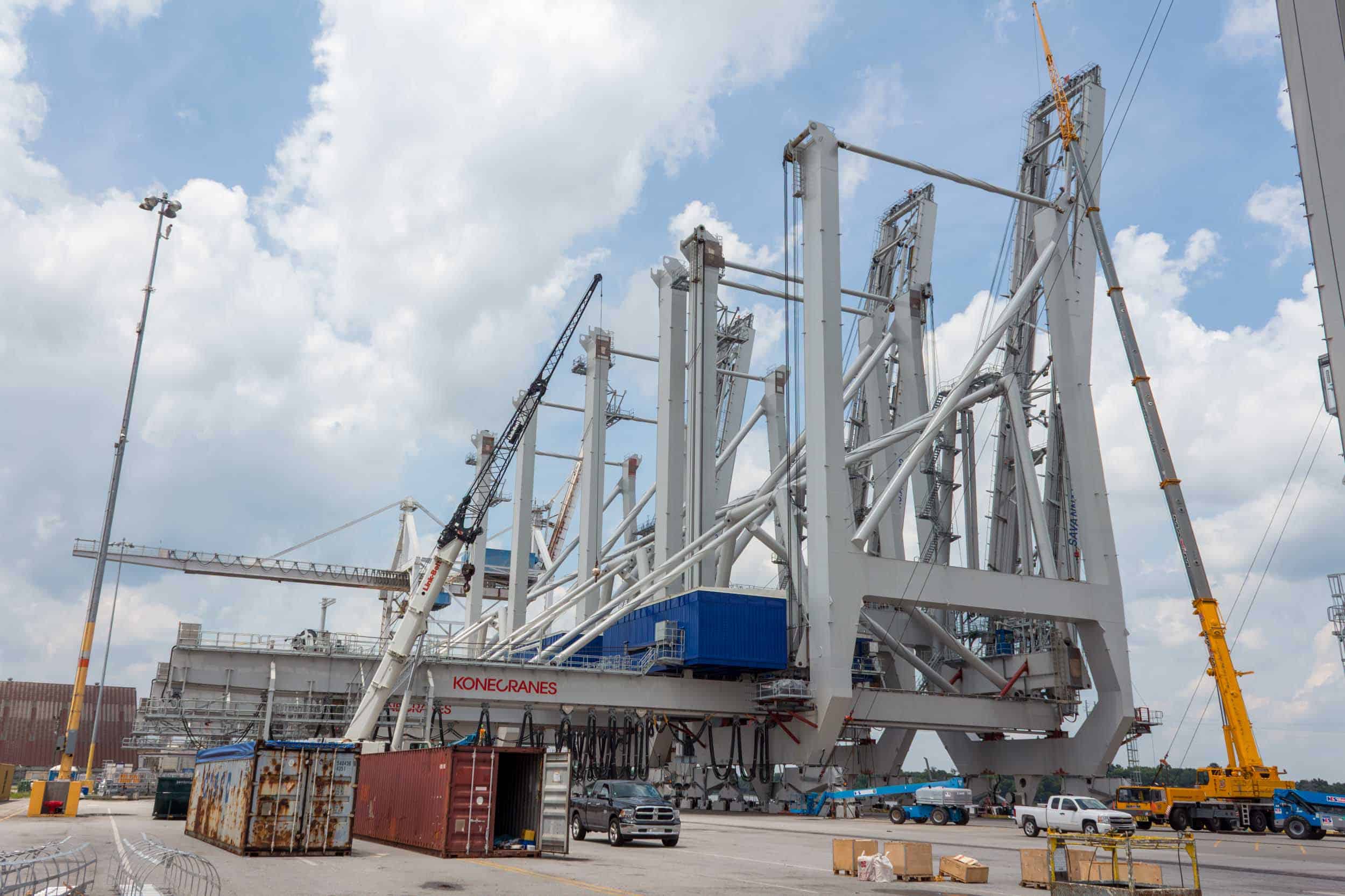 Port crane assembly under cloudy sky