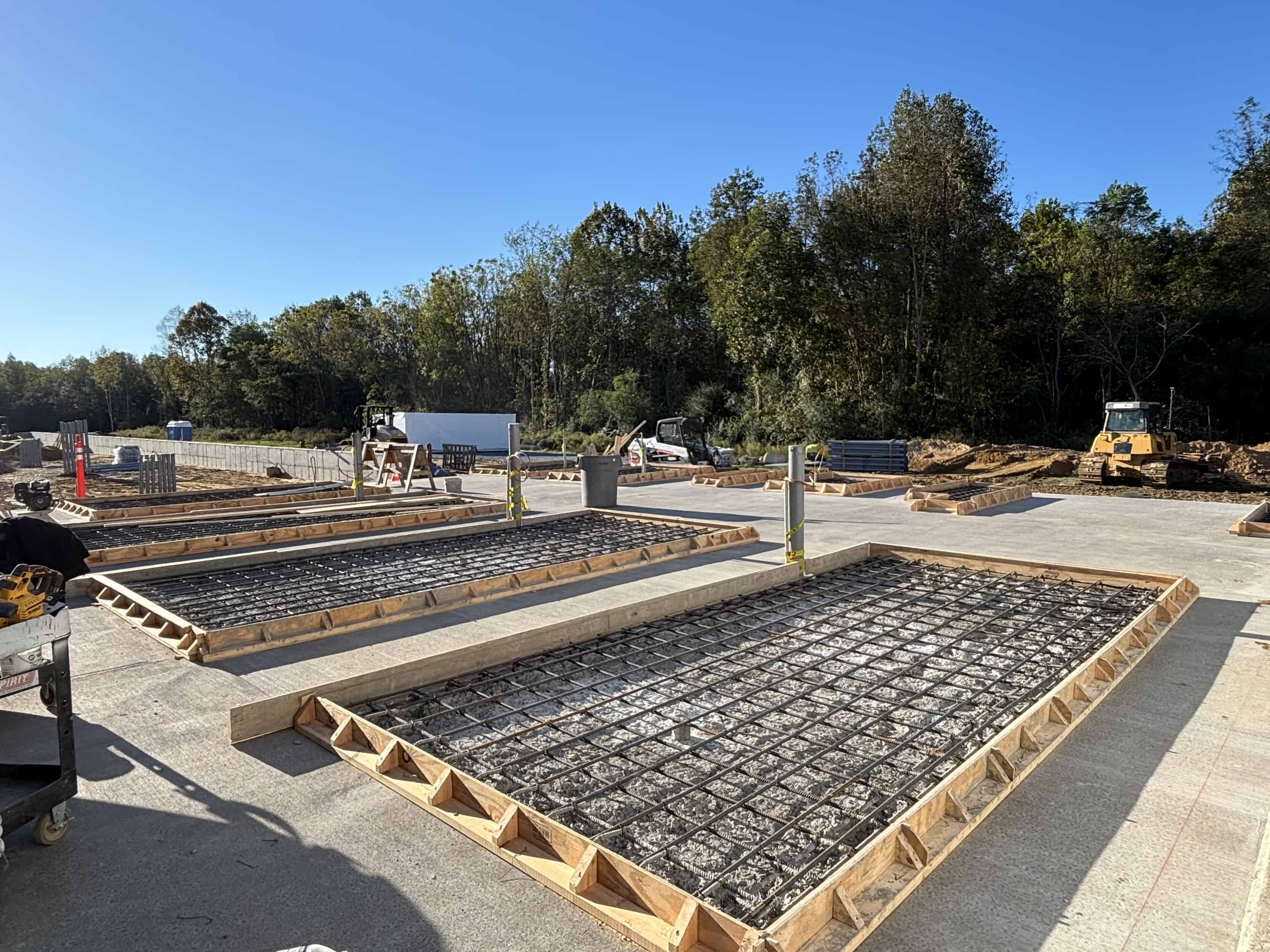 Concrete foundations with rebar on construction site.